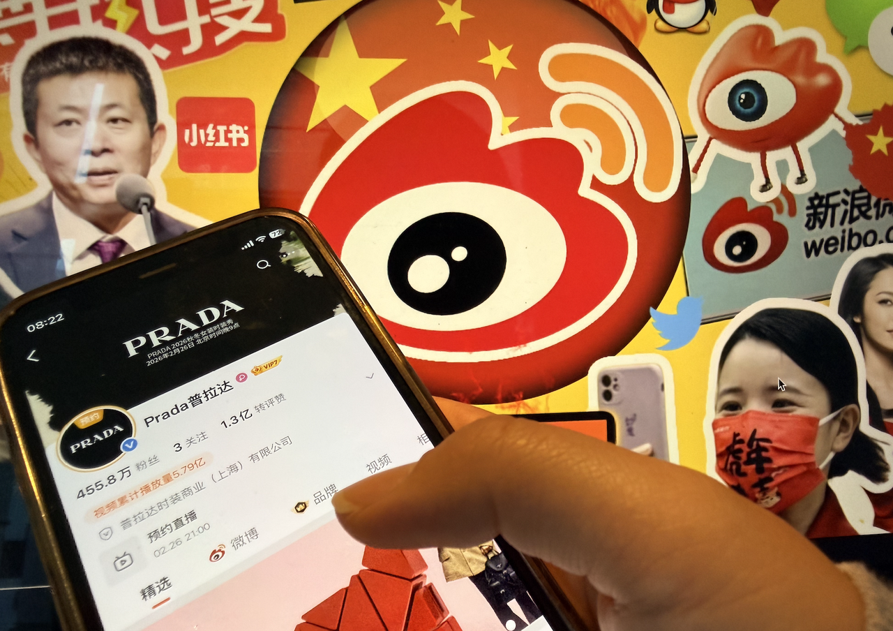 PRADA Weibo account viewed on a mobile phone with Sina Weibo branding